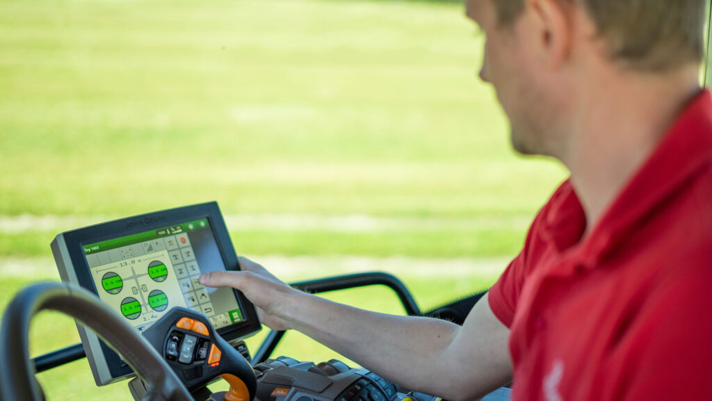 Farmer using the Profiline “comfort” control system in a Pottinger Top VT rake