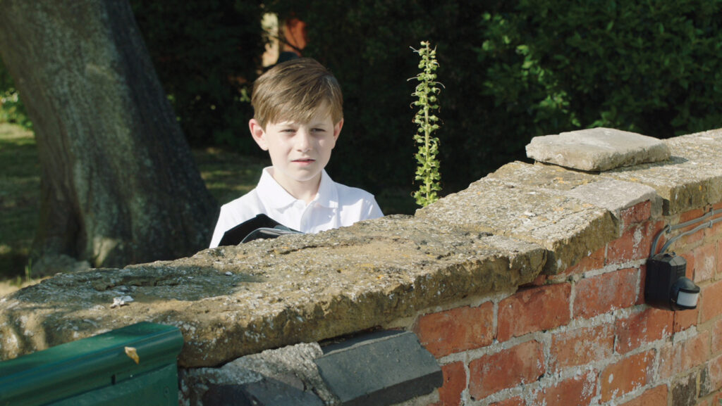 A boy behind a wall