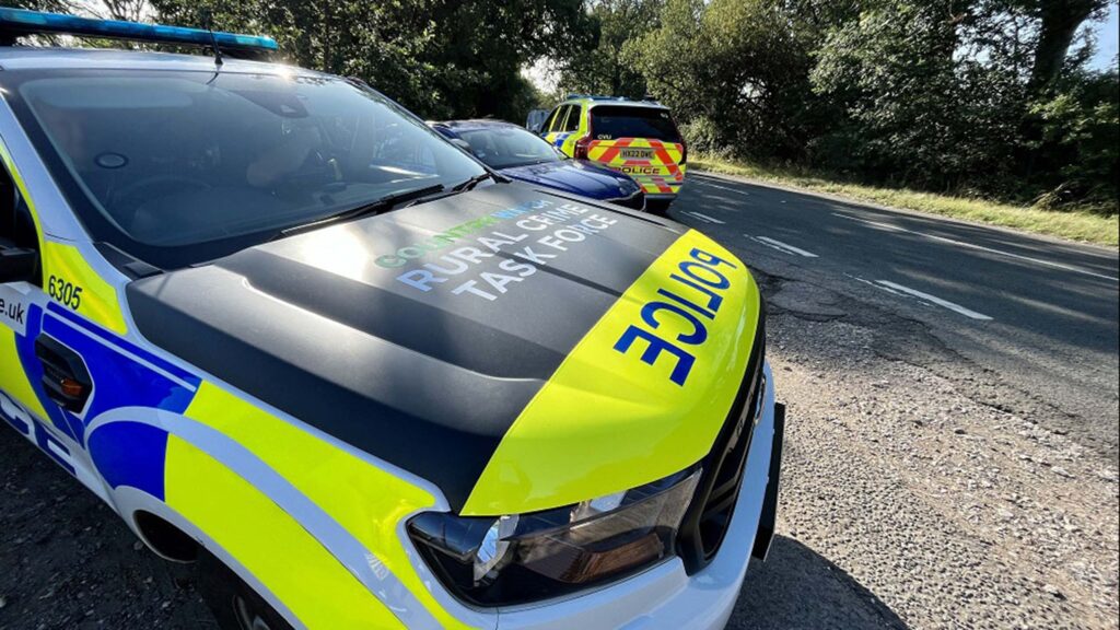 Police cars parked during a raid on a property