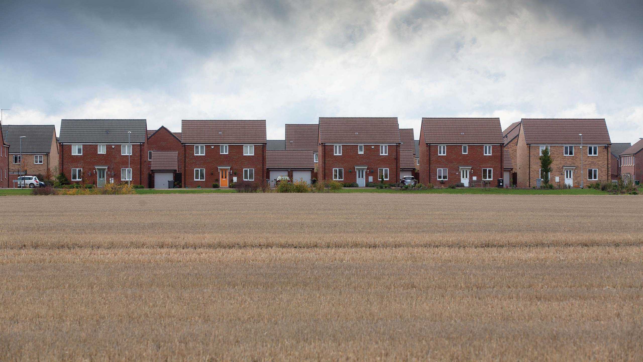 Housing behind farmland