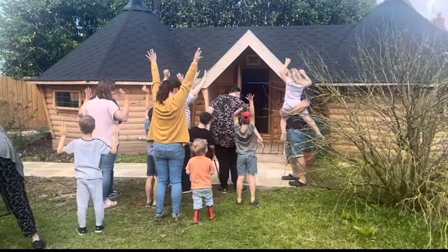 Children and adults shown cheering