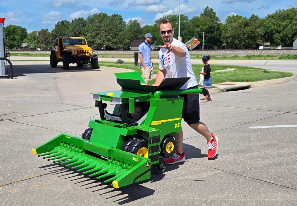 Taylor pushing the John Deere combine stroller