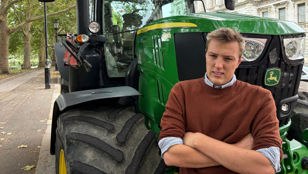 Oli Fletcher leaning against a tractor at the rally