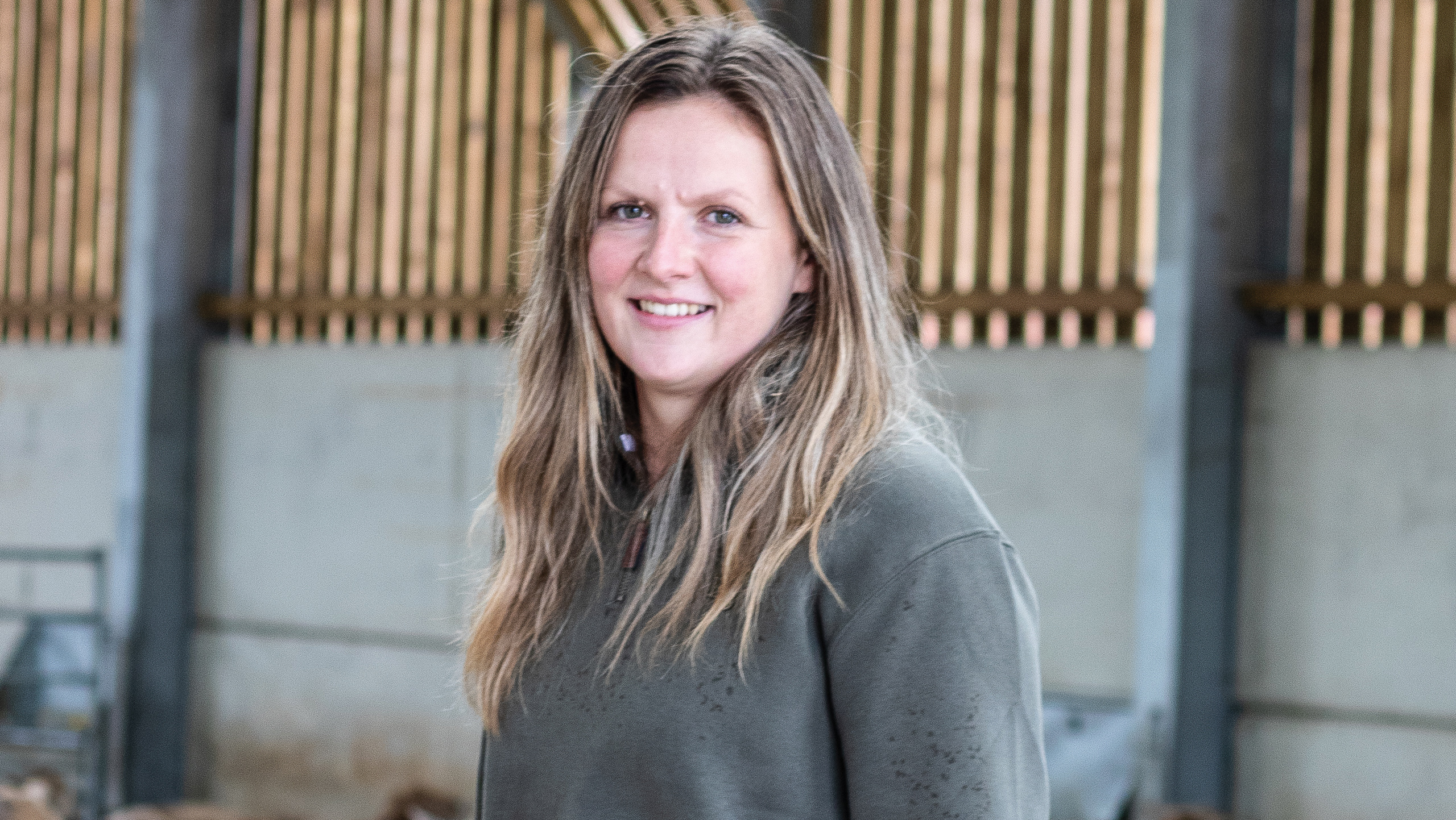 Woman stands inside a shed