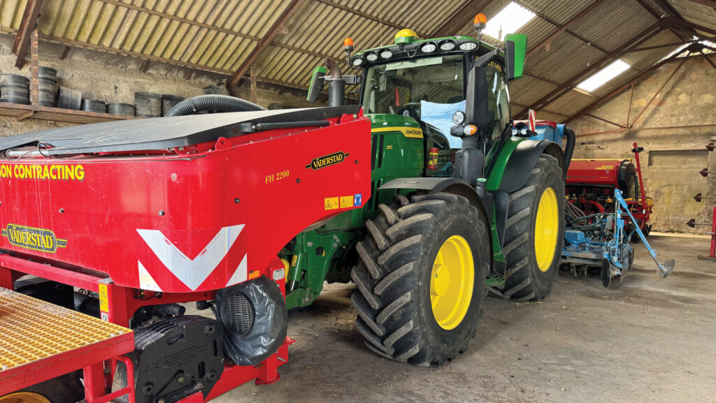 Tractor and drill parked in a shed