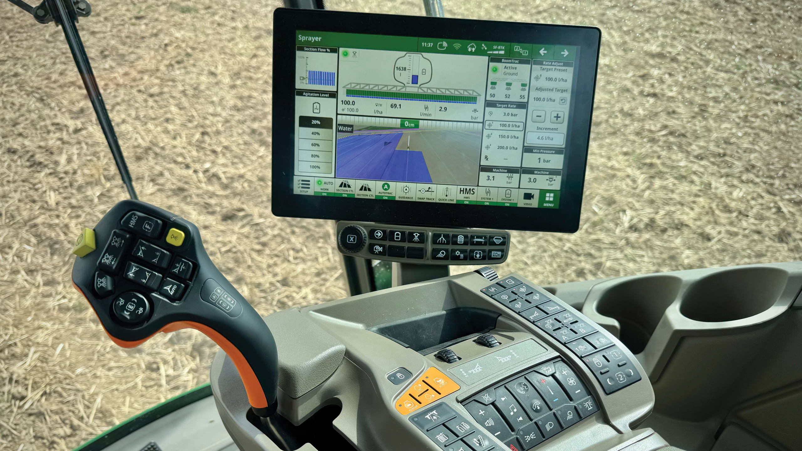 Screen and joystick inside sprayer cab