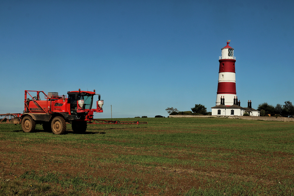 Spraying osr at Walcott Farms with Happisburgh Lighthouse in background