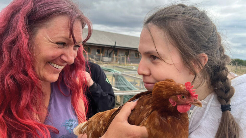 Woman and girl with chicken