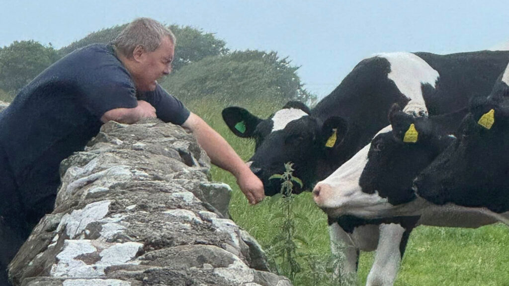 Mike Duxbury with cow on farm, The Inclusive Farm