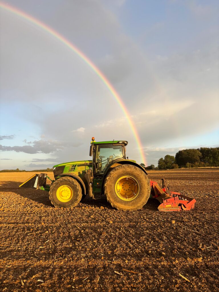 Power harrowing with rainbow in background