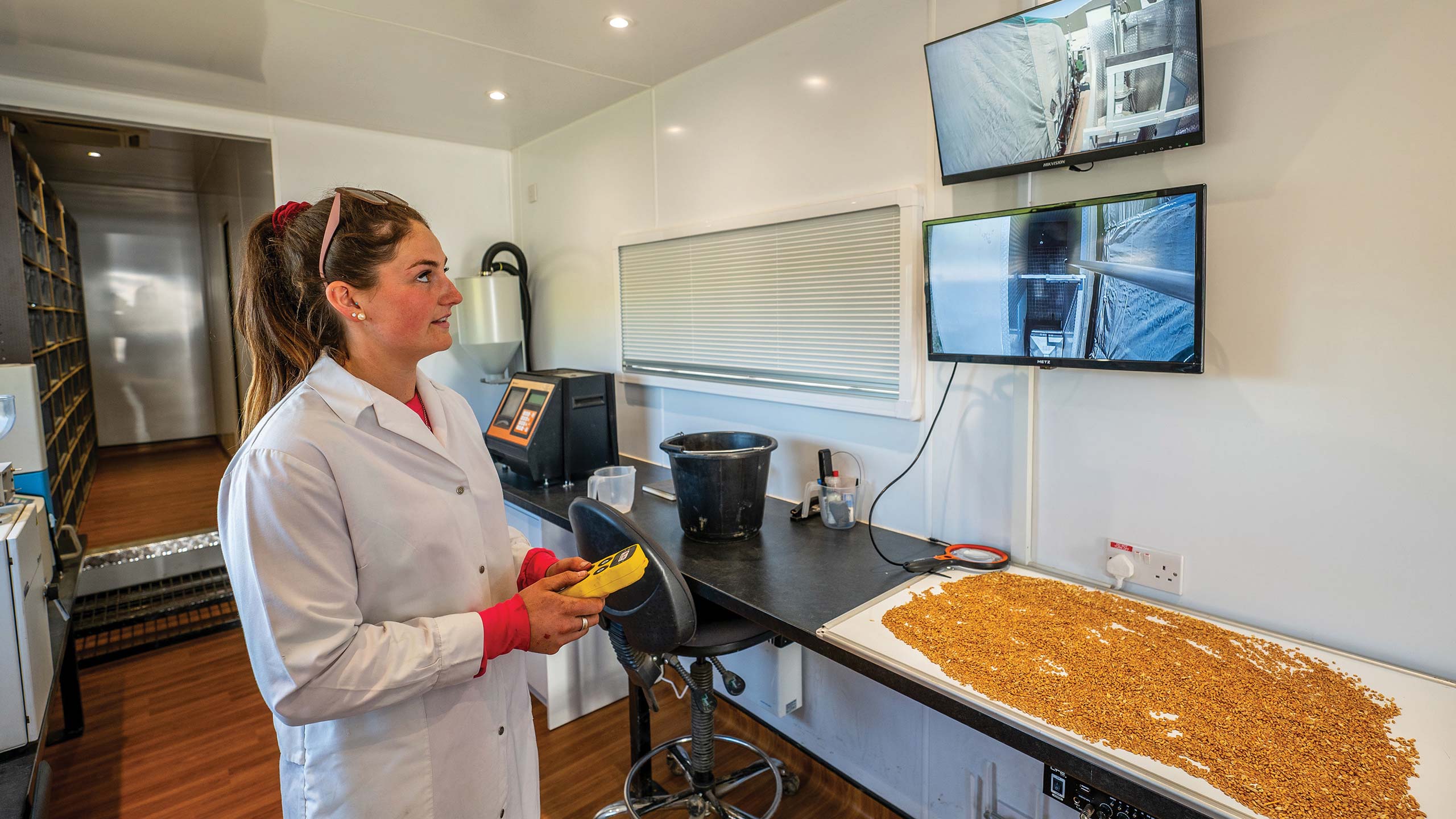 Woman inside testing lab holding remote control