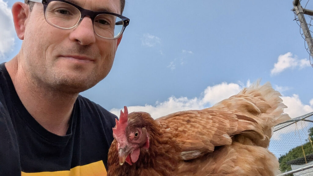 Scott Hodson with one of his hens © The Hodson family