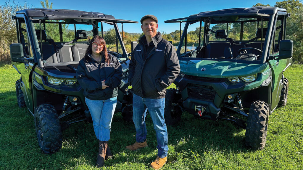 Farmers standing by machinery