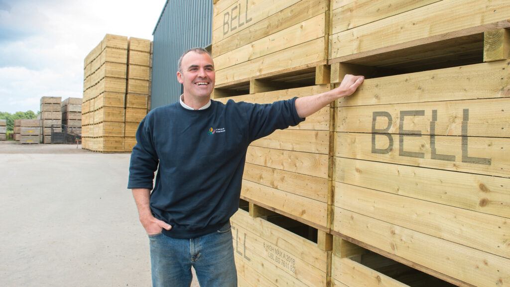 Farmer beside potato storage boxes