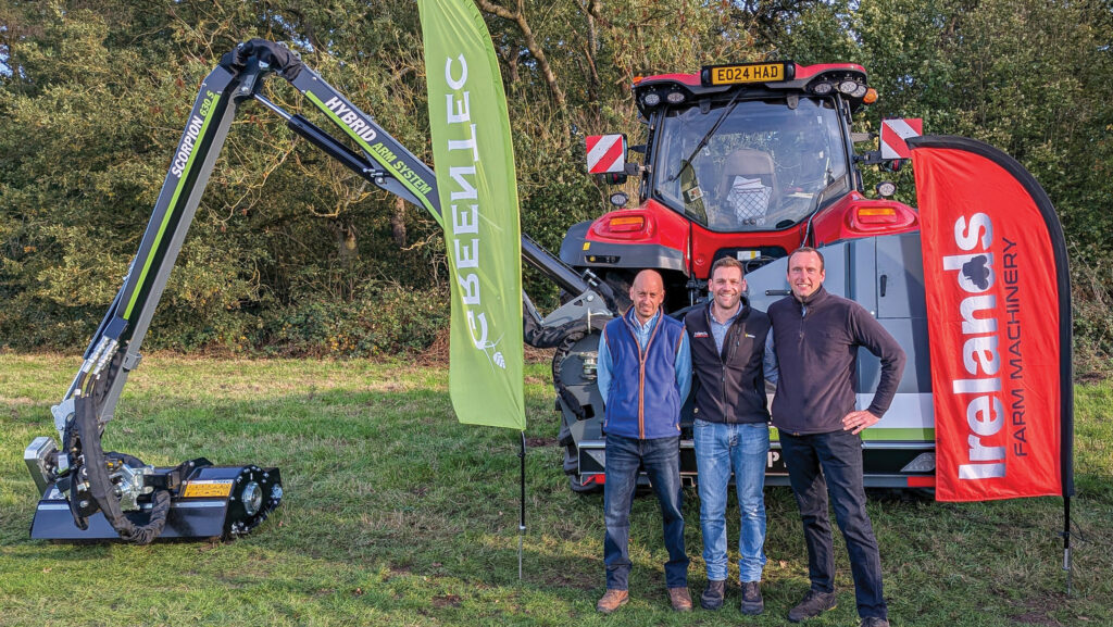 Group standing in front of tractor