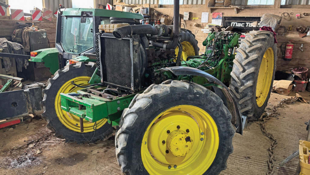Stripped-down tractor in workshop