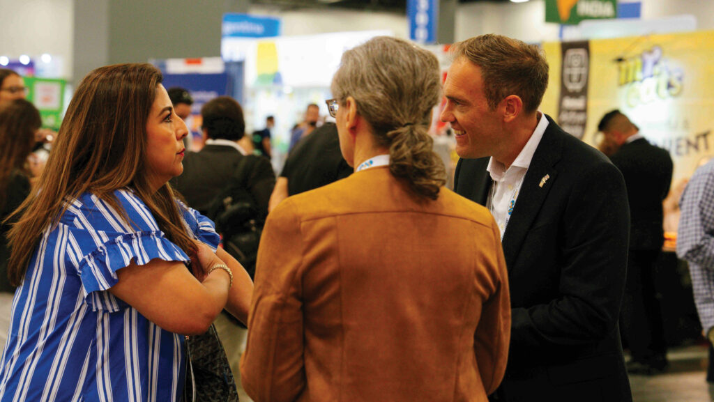 Group of people talking at a trade show