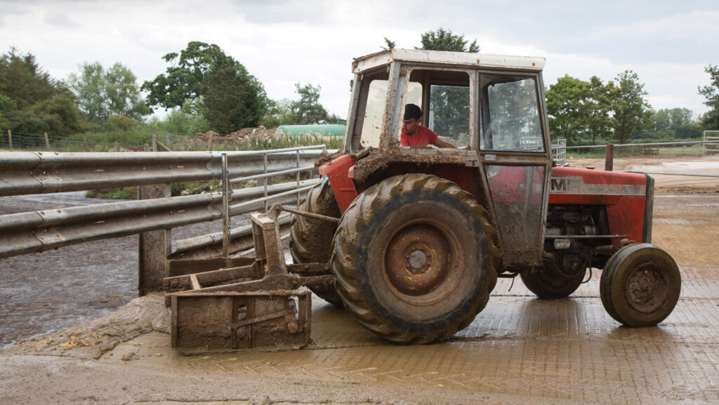 Tractor with slurry scraper