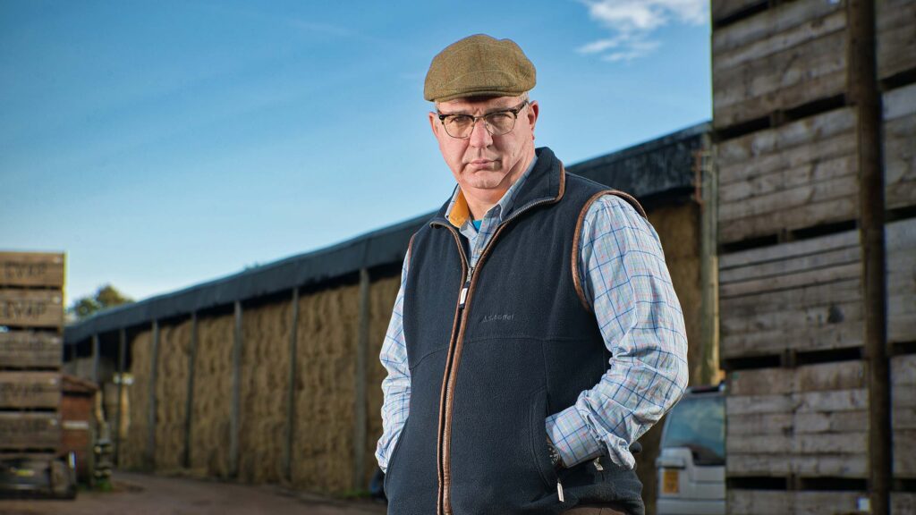 Farmer in front of potato storage boxes