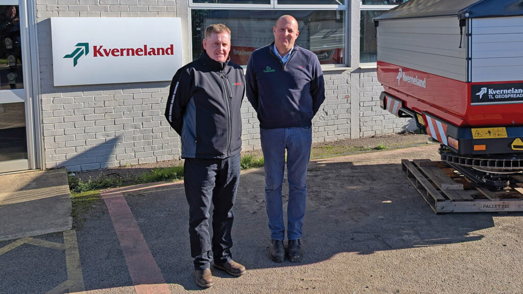 Men standing outside farm machinery dealership