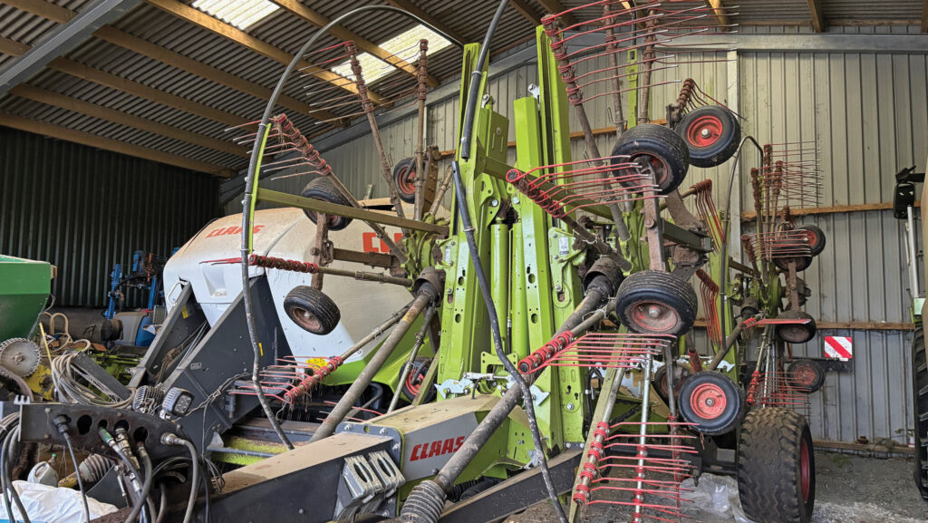 Folded grass rake in a shed