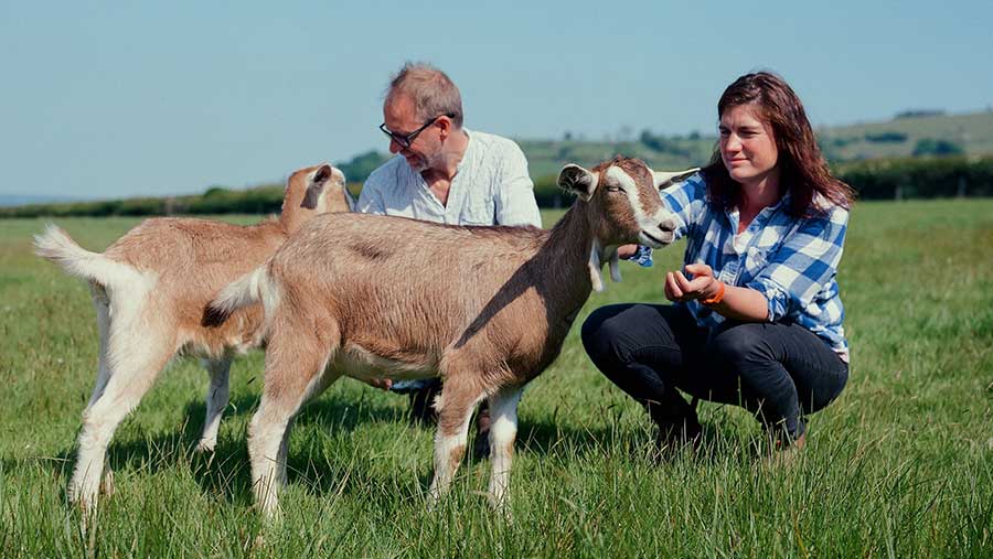 Rachel Yarrow crouched next to a goat