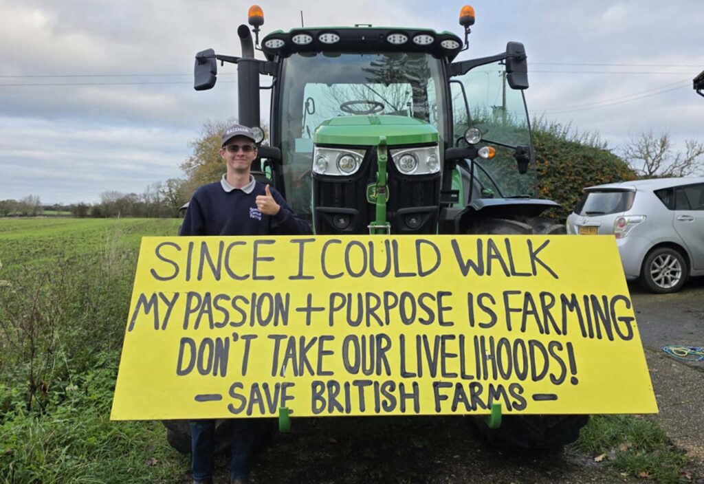 Farmer with sign on front of tractor