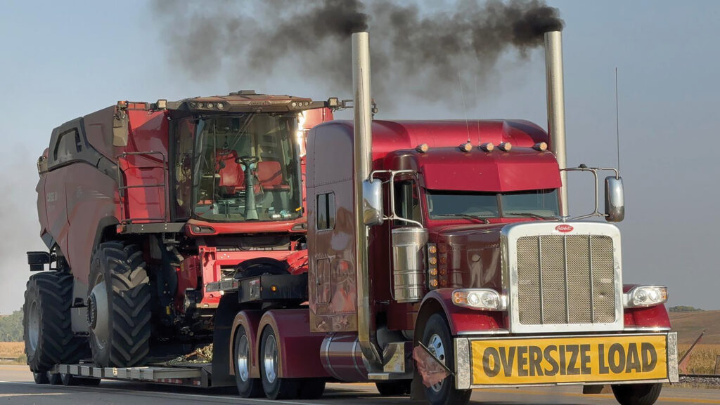 Combine harvester being transported by truck in US