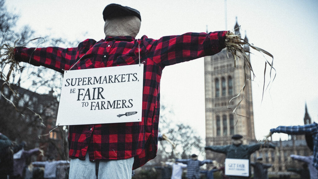 Scarecrow be fair to farmers protest outside Parliament