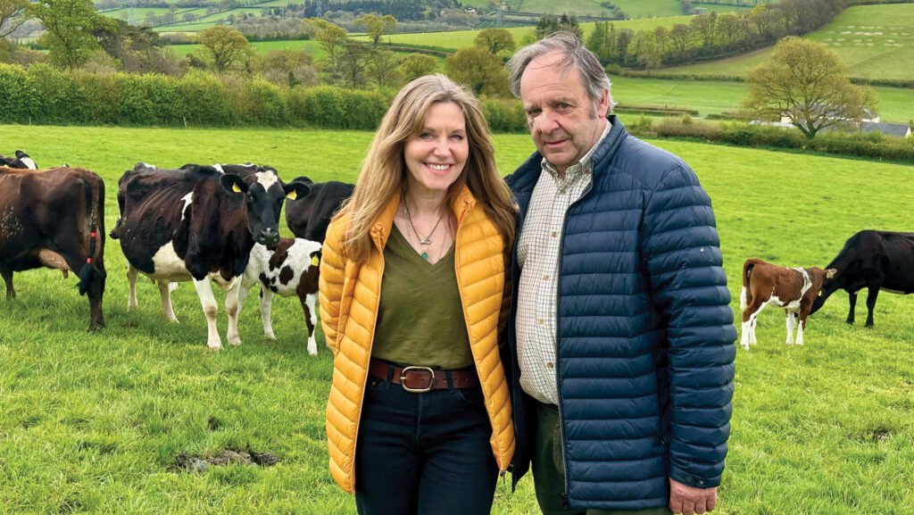 Suzy and Tim Wall in field with cows