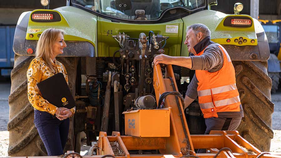 Leonie King, Agent of NFU Mutual stood talking to farm worker