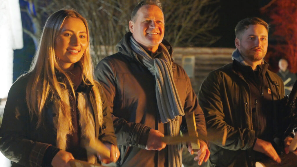 Banging wooden sticks at Thatchers Wassail event