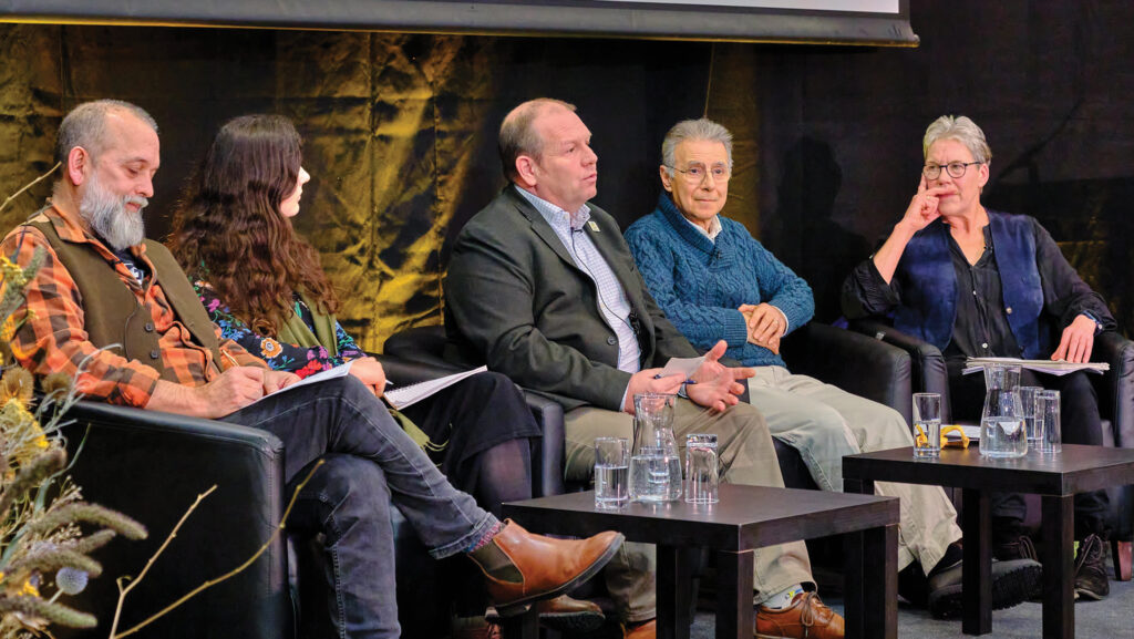 Group sit on stage at a conference