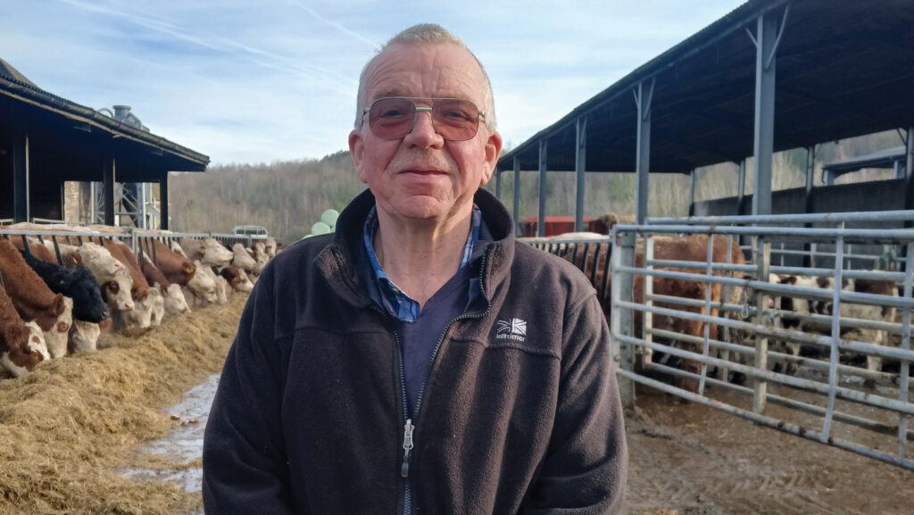 Farmer poses in farmyard