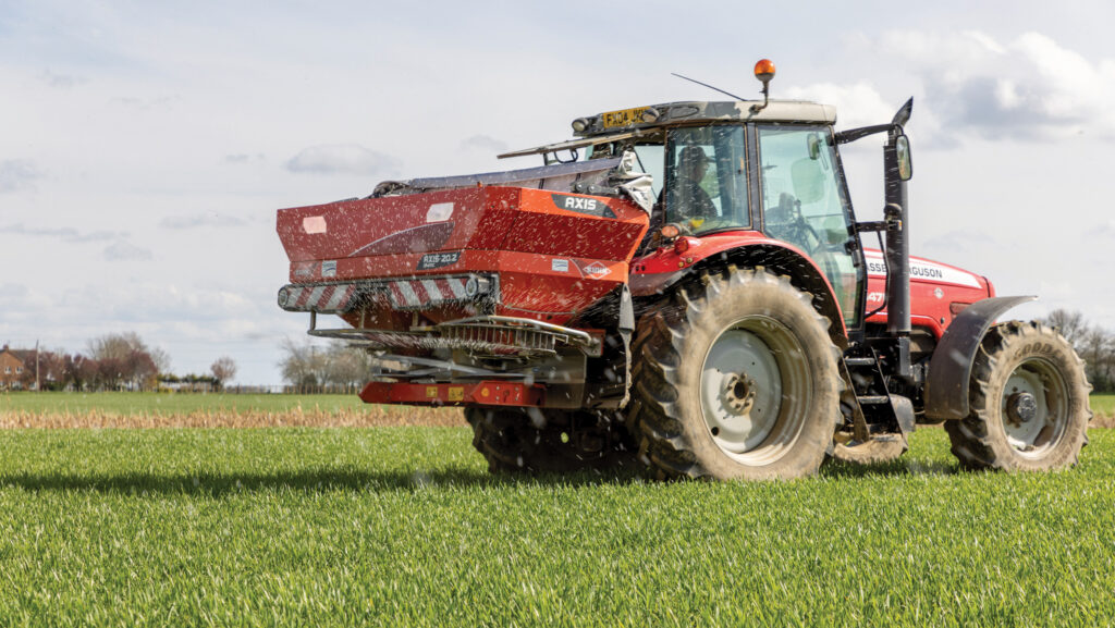 Spreader applying nitrogen to wheat