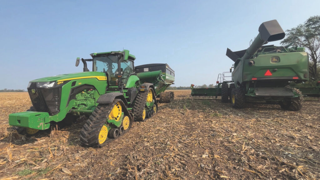 Tractor and combine in field during US harvest