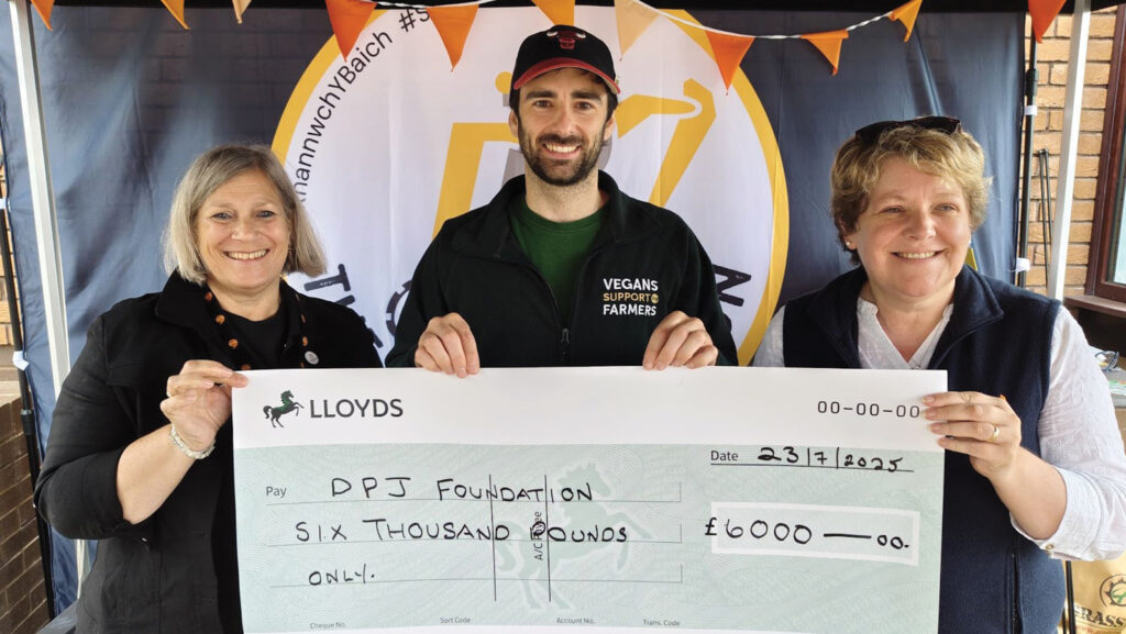 Vegans Support the Farmers members with giant cheque