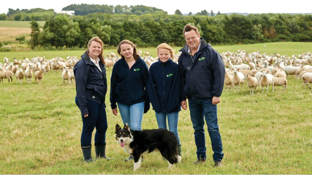 Family stand together with a dog