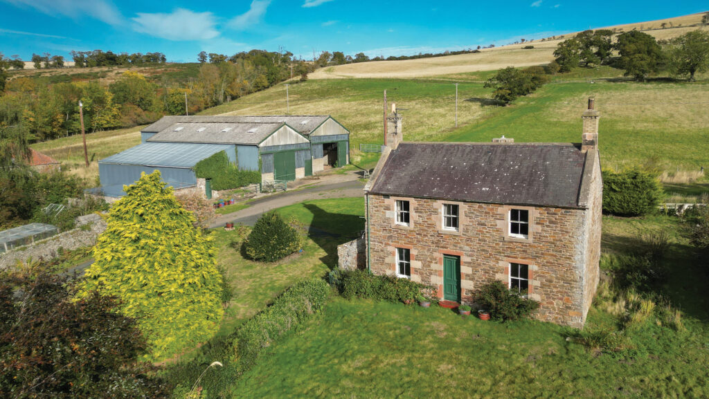Aerial view of farmhouse and other buildings