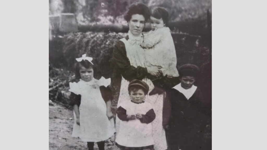 Old photo of woman with four children