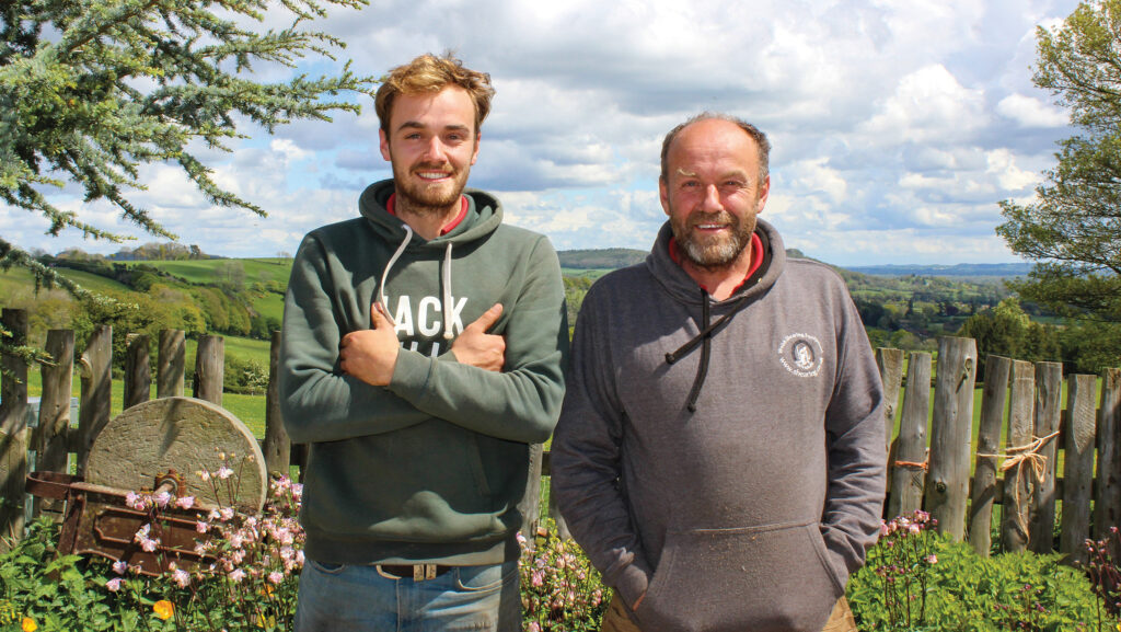 Farming father and son pose for camera