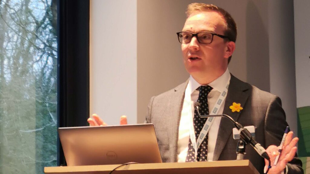 Man stands at a lectern