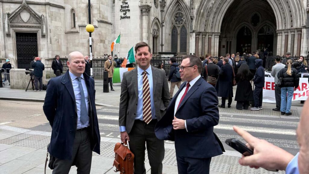 Three men in suits outside court building