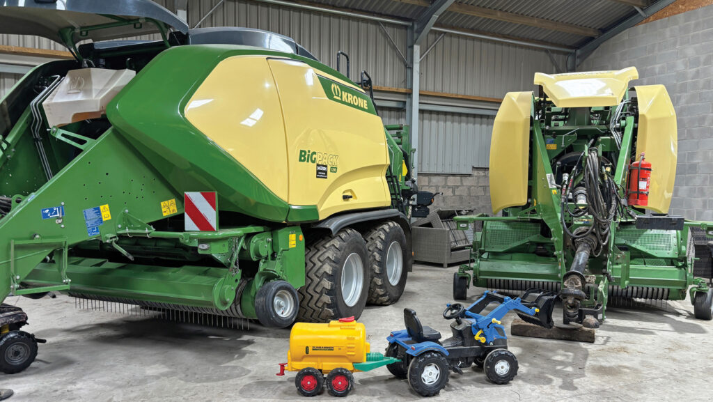 Two balers and a child's tractor in a shed
