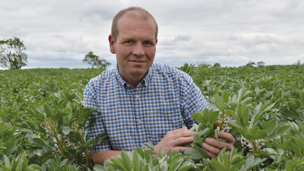 Man poses in a field