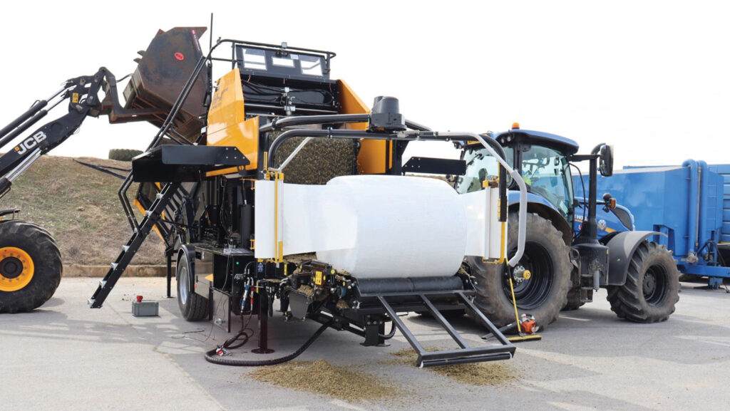 Static baler being fed by a telehandler
