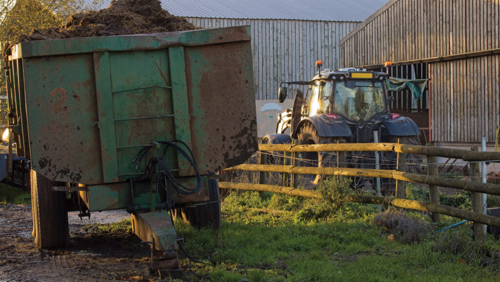 Trailer and tractor in a farmyard