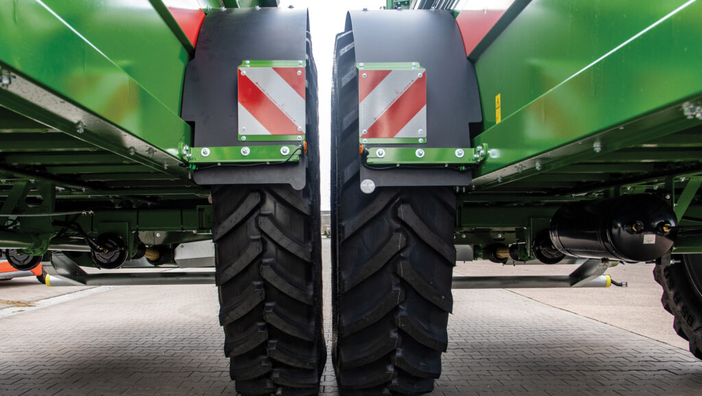 Two spreaders parked side by side showing tyre widths
