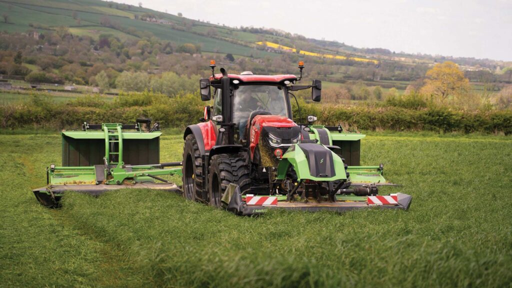 Tractor with triple mowers attached