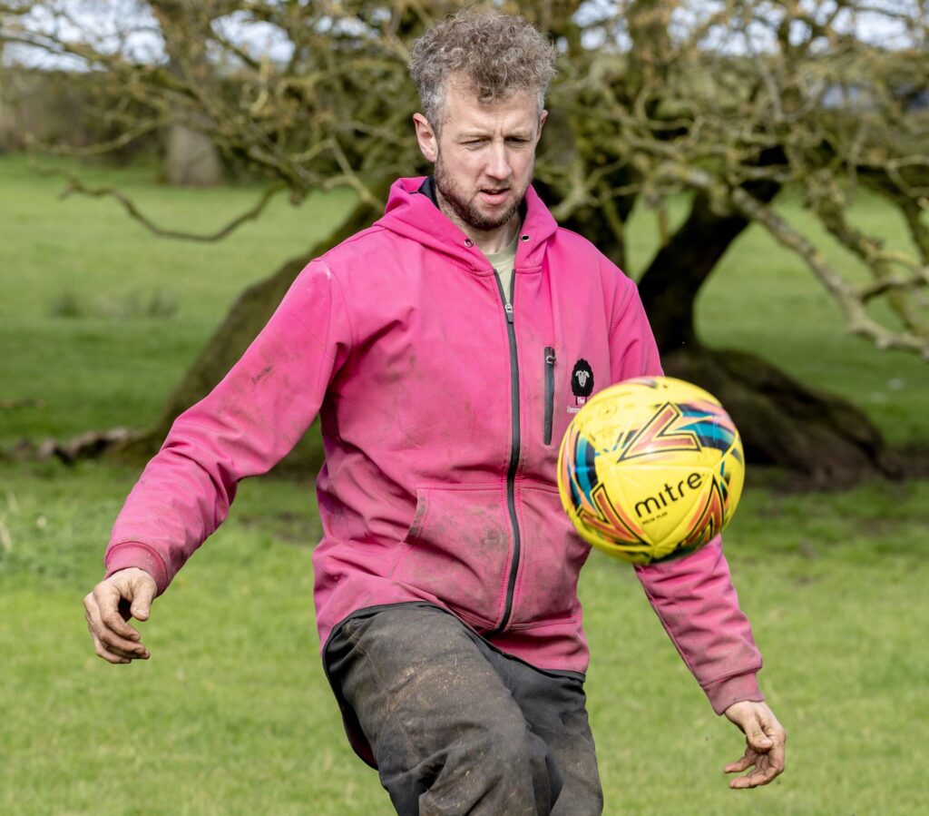 Farmer kicking a football